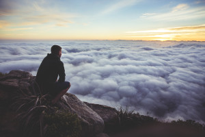 man contemplates - looking at clouds