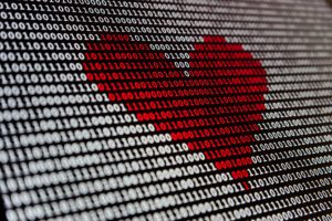 online dating for men. A red heart on computer code