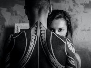 Man with ethnic tattoos, and woman. The masculine and feminine truth