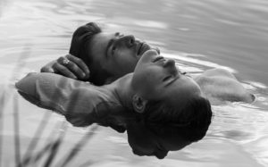 Man and woman close together floating in water Romantic or Tantric