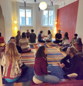 Wide shot of workshop participants doing an exercise in pairs.